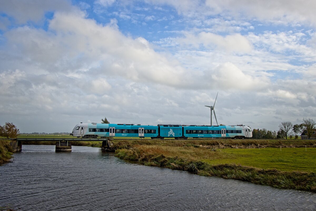 Triebwagen 605  Noorderzon  überquert auf dem Weg nach Stavoren kurz hinter dem Bahnhof Hindeloopen die Oostervaart (20.10.2021)