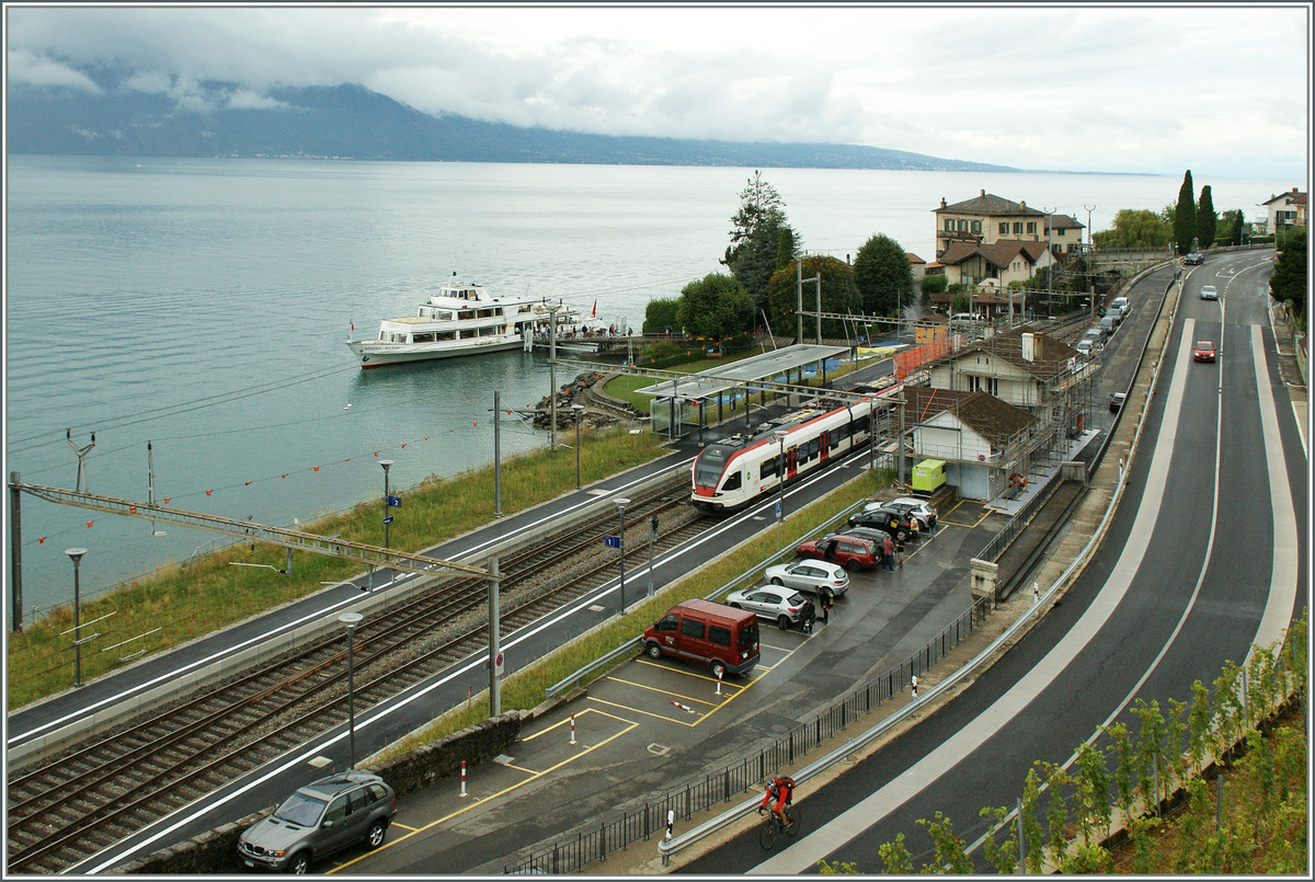 Trotz einer erfreulich hohen Frequenz auf der Strecke Lausanne - Villeneuve ist es nur selten mglich zur richtigen Zeit am richtigen Ort zu sein und ein  Zug mit Schiff Bild  zu bekommen. 
Heute in Rivaz ist es nach langem wieder einmal geglckt.
Whrend das CGN Kursschiff in Rivaz-St Saphorin angelegt hat, fhrt ein Flirt als S3 ohne Halt durch Rivaz.
8. Sept. 2013  