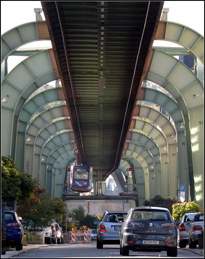 Überbauung einer Stadtstraße -

Aus dieser Perspektive wirken die Anlagen der Wuppertal Schwebebahn schon sehr wuchtig. Die Mauer im Hintergrund erinnert mich an das geteilte Berlin oder das heutige Betlehem. Es handelt sich aber um Lärmschutzmauern an der dortigen Autobahnauffahrt. Die früher mal unter der Schwebebahn verlaufende Straße von Vohwinkel nach Sonnborn ist dadurch heute unterbrochen. Die Aufnahme entstand in Sonnborn.

04.10.2014 (Js)