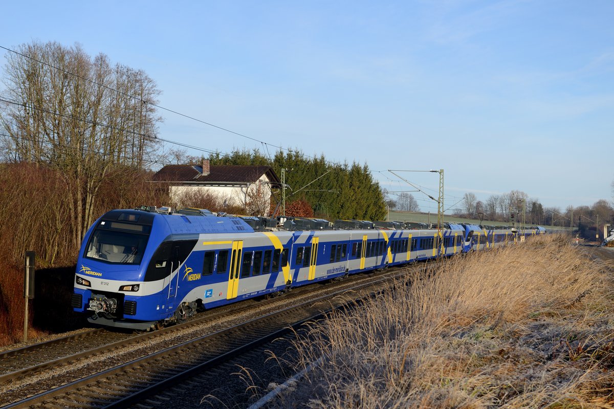 Und dann kam der Fahrplanwechsel und mit ihm die neuen FLIRT Triebzüge des Meridian. Gerade noch im letzten Moment erteilte das EBA die Betriebsgenehmigung. Allerdings sind noch nicht alle der 30 Triebzüge ausgeliefert und auch der Schadbestand soll noch beträchtlich sein. So mußte ein Ersatzzugkonzept aufgestellt werden, der eine illustre Fahrzeugvielfalt auf die KBS 950, 91 und 958 bringt. Unteranderem sind im Einsatz: ÖBB 1142 mit Inlandsreisezugwagen (CityShuttle), DB AG 111 mit n-Wagen, Triebwagen der ODEG und der Vogtlandbahn, Doppelstockwagen des Metronoms und eine FLEX-Wendezuggarnitur, jeweils bespannt mit ES 64 U2. Am 15. Dezember 2013 wurde der M 79011 allerdings schon mit ET 312 und einem weiteren FLIRT gefahren, aufgenommen bei Vogl.