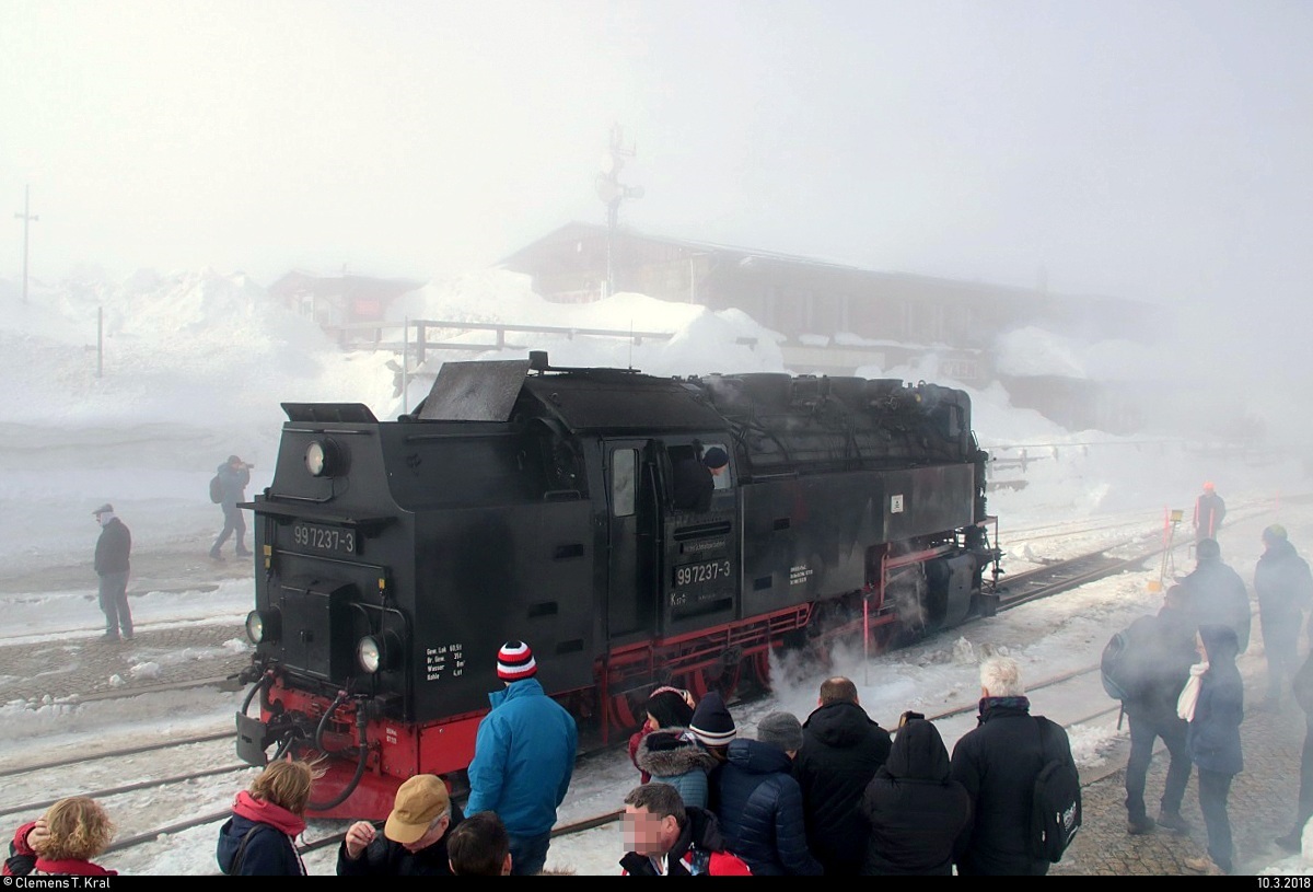 Unter Beachtung zahlreicher Gäste und vor dem Bahnhofsgebäude rangiert 99 7237-3 der Harzer Schmalspurbahnen GmbH (HSB) im Bahnhof Brocken, um die Rückfahrt vorzubereiten. Dadurch ist die Lok leider etwas verdeckt. [10.3.2018 | 12:13 Uhr]