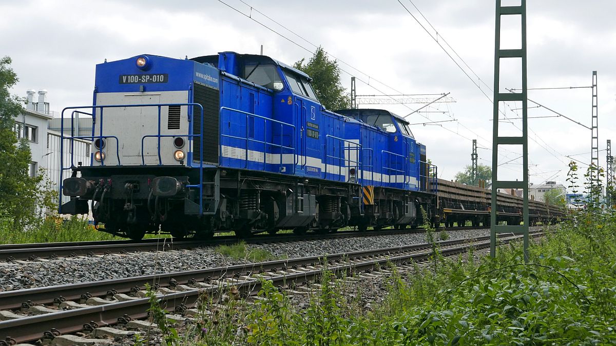 V 100-SP-010 und V 100-SP-009 von SPITZKE mit einem Altschwellenzug in Fahrtrichtung Ulm kurz vor dem Bahnhof Biberach (Riß) am 22.08.2019.