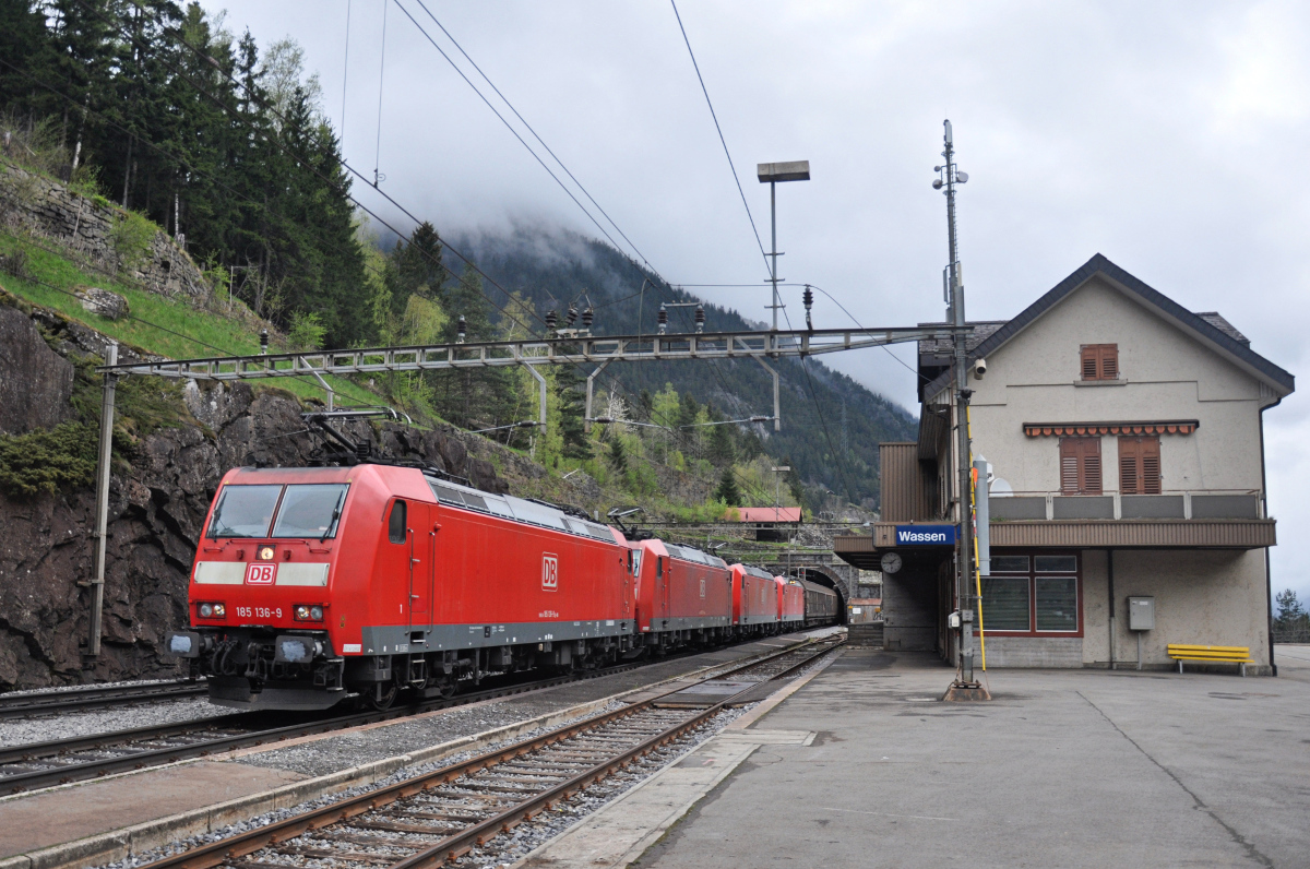 Vergängliches am Gotthard: Der Bahnhof Wassen ist seit Jahren nicht mehr besetzt, den Regionalverkehr haben Busse vor vielen Jahren übernommen. Nur noch ausnahmsweise halten Züge in Wassen, dann steht jedoch meistens eine Überholung oder Kreuzung infolge Einspurbetrieb an. Diese vier BR 185 der DB, zuvorderst die 185 136-9, können Wassen am 28.04.2015 ungehindert mit ihrem Güterzug passieren. 