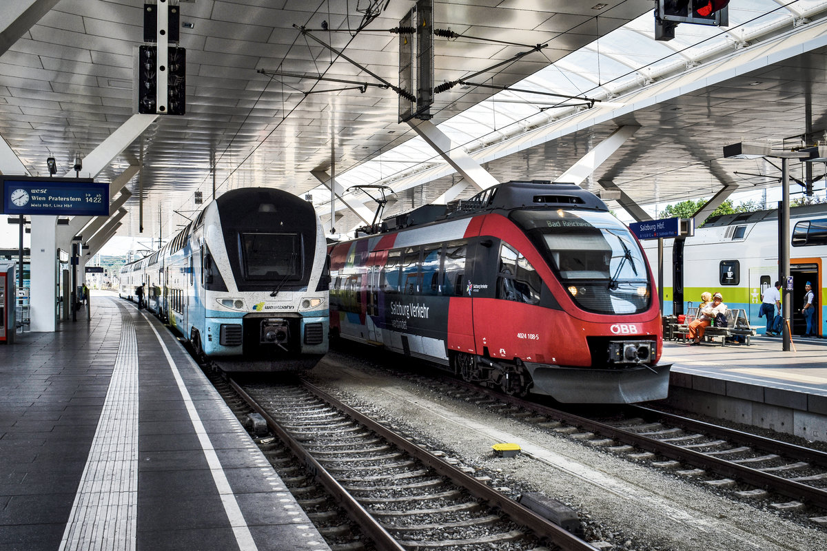 Während links 4110 114 als west 969 auf die Abfahrt nach Wien Praterstern wartet, fährt links 4024 108-5 als S3 25718 (Schwarzach-St. Veit - Bad Reichenhall) in den Bahnhof ein.
Aufgenommen am 26.7.2018, in Salzburg Hbf.