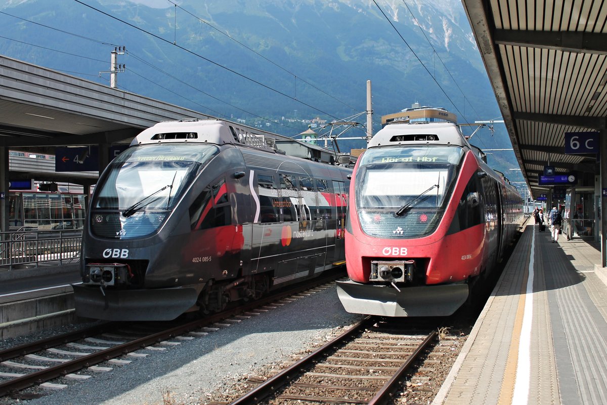Während ÖBB 4024 080-6 als REX nach Wörgl auf Gleis 6 im Hauptbahnhof von Innsbruck stand, wartete am Nachmittag des 30.06.2018 der ÖBB 4024 085-5  mastercard  als REX nach Brenner/Brennero auf Gleis 5 auf seine Ausfahrt.