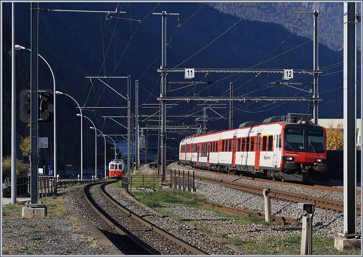 Während der RegioAlps Domino Regionalzug 6117 von St-Gingolph nach Brig in Kürze den Bahnhof von Martigny erreicht, ist der M-C BDeh 4/4 N° 8 im Hintergrund schon auf den Weg nach Vernayaz MC. 

18. Nov. 2018