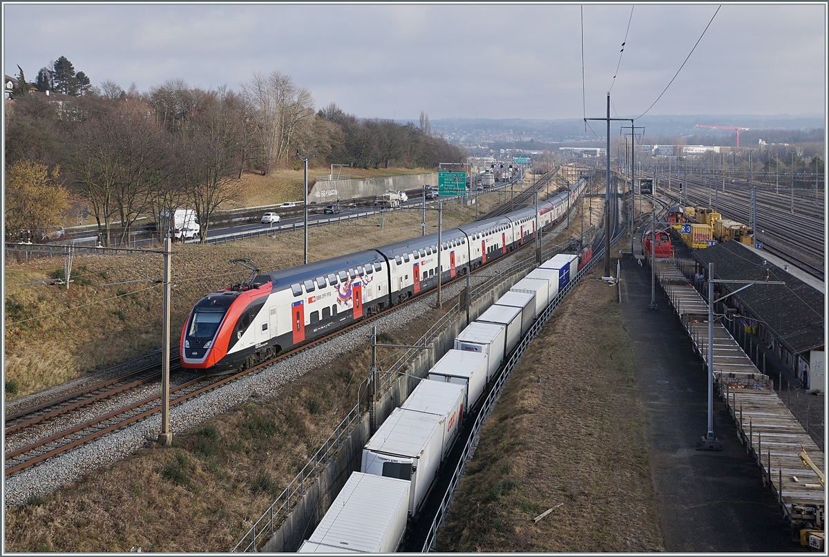 Während der SBB RABDe 502 009-9  Stadt St.Gallen und ein weiterer Twidexx sich auf der Fahrt nach Genève Aéroport der Haltestelle Denges-Echandens nähern, verlässt ein Güterzug den Bahnhof Lausanne Triage. 

4. Februar 2022