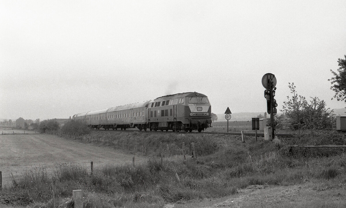 Wendezugeinheit, von DB 215 018-3 geschoben, hat Vorsignal vom Bahnhof Kranenburg passiert und fährt über die Grenze gen Niederlande. Der Graben im Vordergrund bildet die Grenze. Kranenburg am 26.05.1991, 10.39u, Scanbild 201.8985, Ilford FP4.