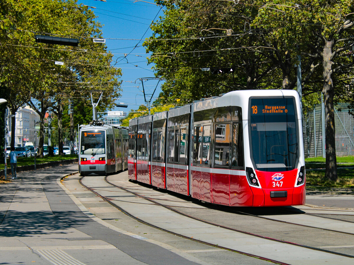 Wien. Flexity 347 trifft hier am 12.08.2023 auf ULF 633 kurz vor der Haltestelle Westbahnhof.
