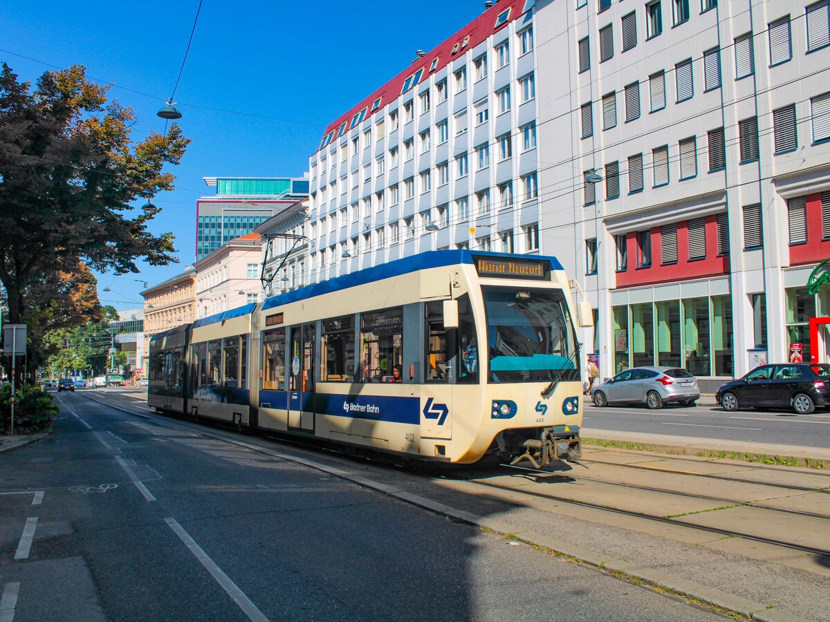 Wien. Triebwage 405 der Badner Bahn hat hier am 12.08.2023 die Haltestelle Johann-Strauß-Gasse verlassen und fährt in Richtung Vösendorf.