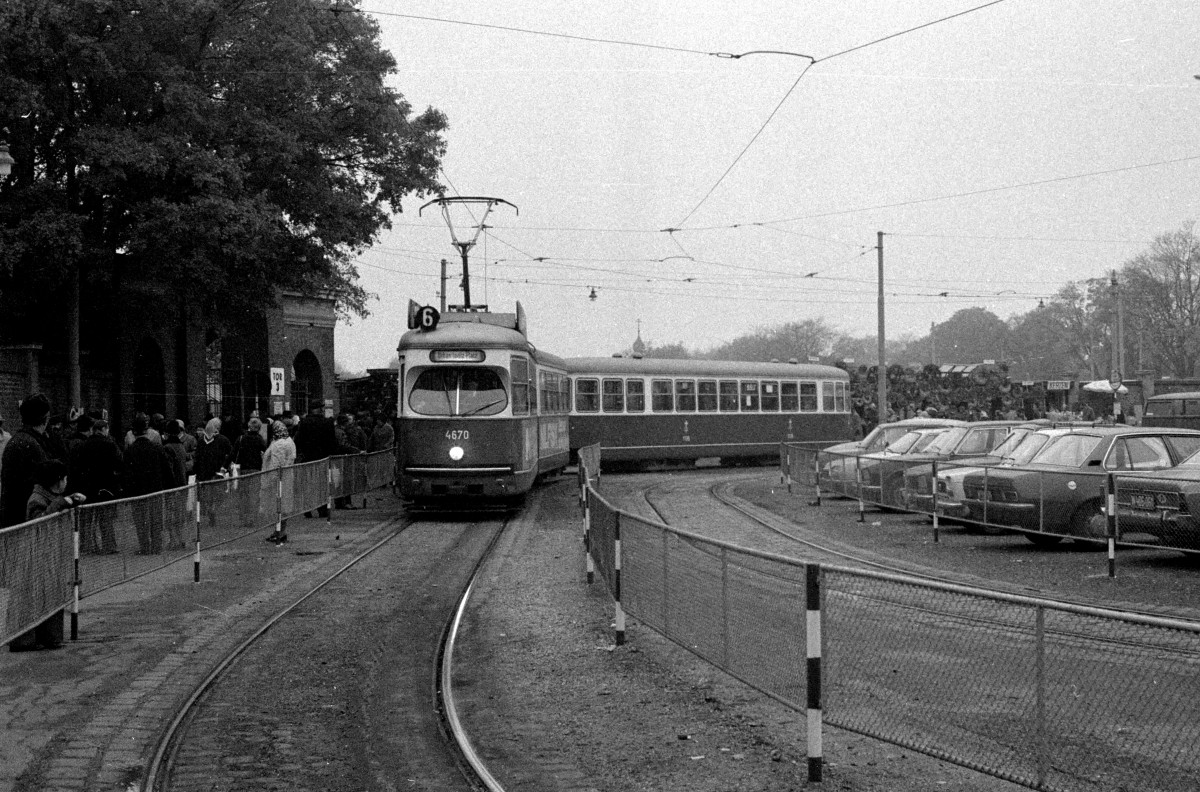 Wien Wiener Verkehrsbetriebe Allerheiligenverkehr 1975: Ein Zug der SL 6 (E1 4670 + c3 1136) hat am 1. November 1975 die Endstation vor dem 3. Tor des Zentralfriedhofs erreicht und die Fahrgäste an der Ankunftshaltestelle abgegeben. Auf dem Bild fährt der Zug zur Abfahrtshaltestelle (hinter dem Fotografen), um Fahrgäste in Richtung Urban-Loritz-Platz über Geiselbergstraße, Quellenstraße, Margaretengürtel, Gumpfendorfer Gürtel, Mariahilfer Gürtel und Neubaugürtel / Westbahnhof zu befördern.