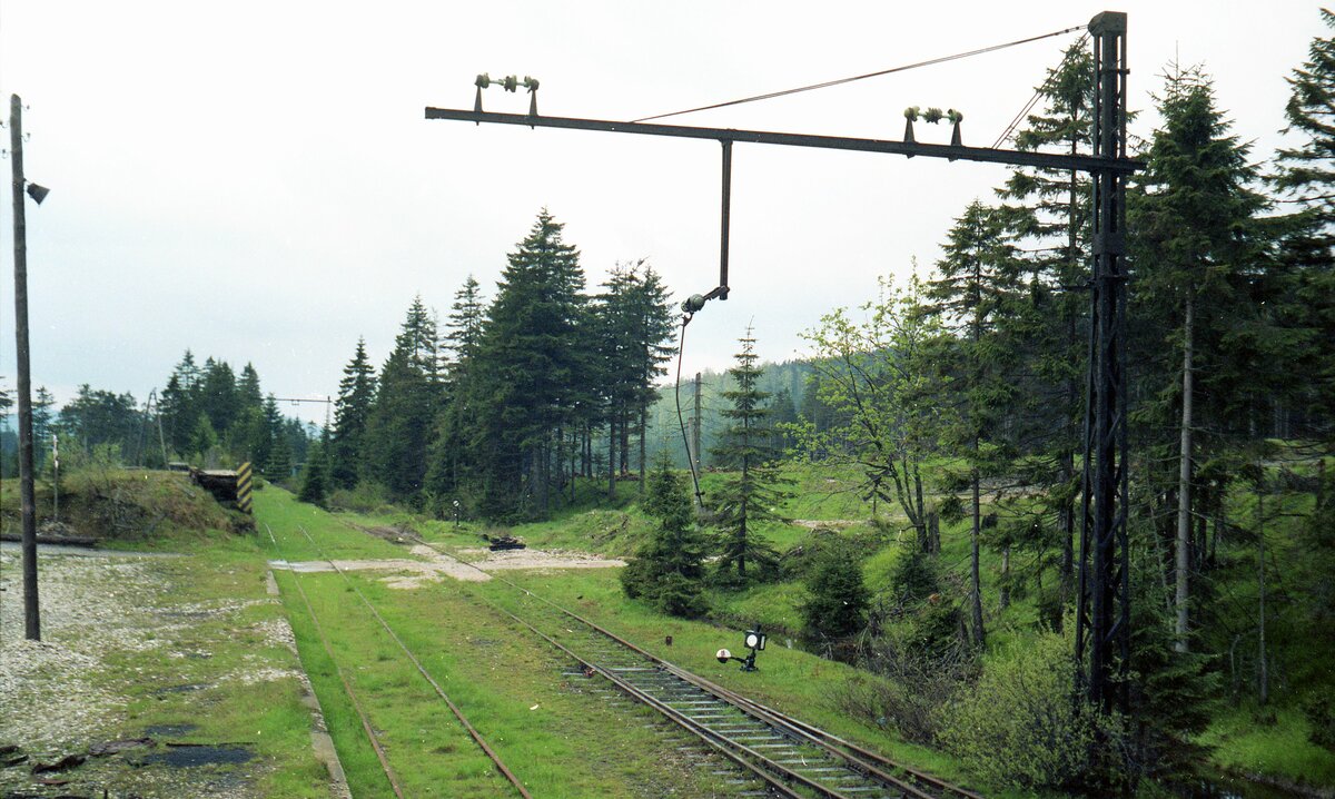 Zacken-Bahn Hirschberg–Schreiberhau (Jelenia Góra-Szklarska Poręba)__Der höchstgelegene Bahnhof der nach Böhmen (Tschechien) weiterführenden Strecke (heute höchst gelegener Bf. in Polen): Jakobsthal (Jakuszyce) 886 m über NN. Der Blick geht Richtung Josephinenhütte (Szklarska Poręba Huta), frühere Glashütte, -Schreiberhau (Szklarska Poręba ). Die Reste der seit 1923 existierenden und 1945 für die Sowjet-Union demontierten Oberleitungsanlagen.__03-06-1991 