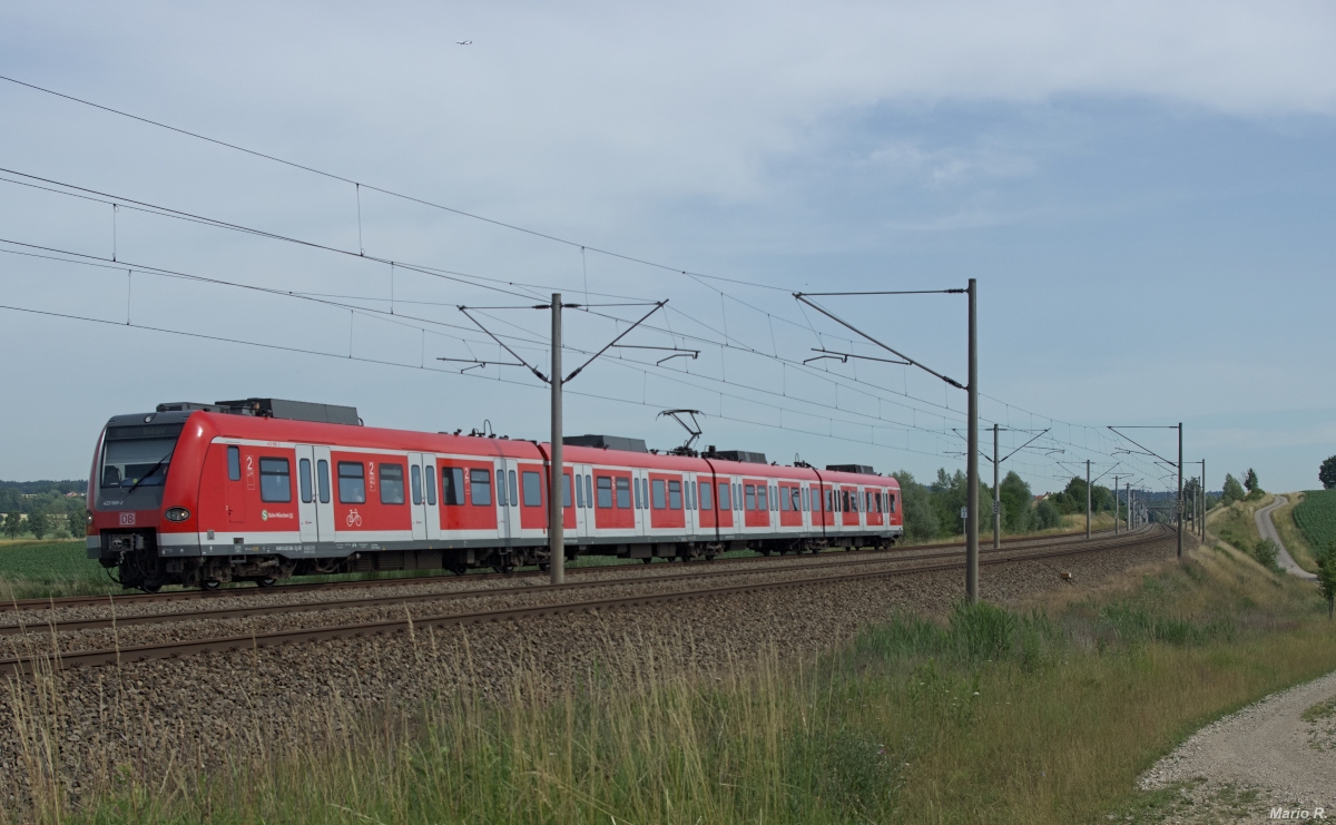 Zug und Flug gibt es wenn der Zufall so möchte bei Petershausen. Während gut erkennbar 423 160 der S-Bahn München sich als S2 nach Erding auf dem Weg befindet ist im oberen Teil des Bildes ein Airbus A330 der Lufthansa sichtbar.
Aufgenommen am 4.7.2014 in Asbach bei Petershausen.