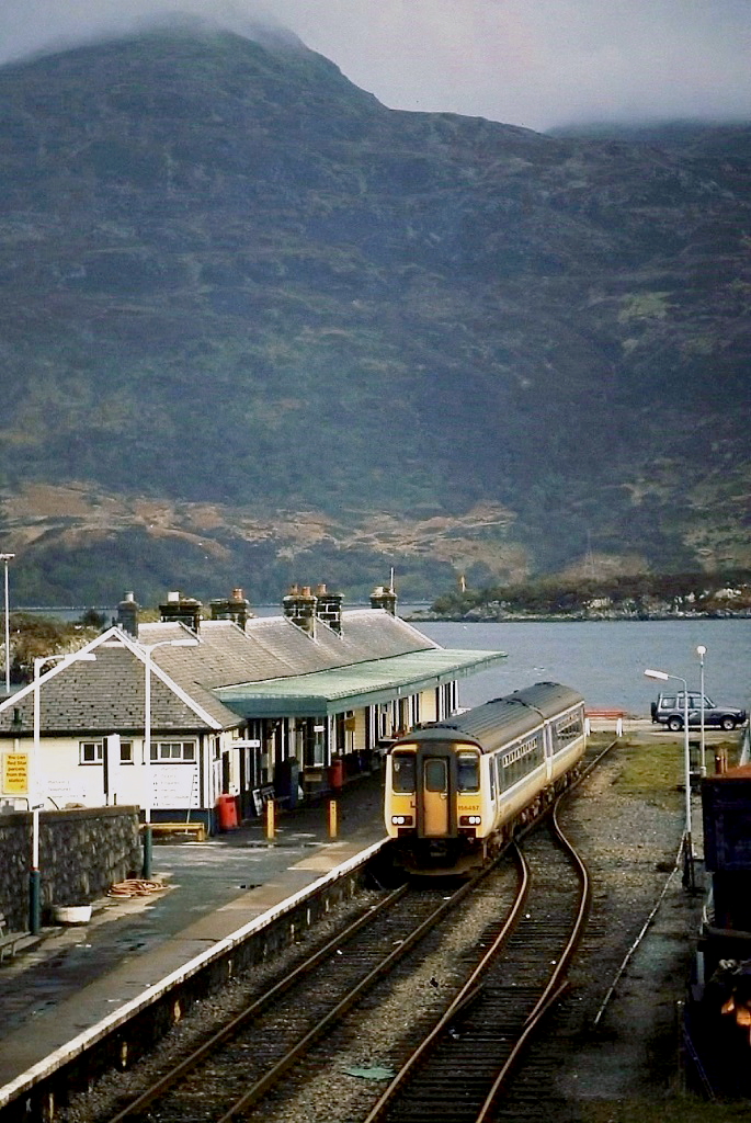 Zwar nicht am Ende der Welt, aber auch nicht weit entfernt davon liegt der Bahnhof von Kyle of Lochalsh, Endpunkt der Strecke von Inverness. Im April 1992 hat 156 457 nach knapp vierstündiger Fahrt durch die einsame Landschaft des schottisches Hochlandes sein Ziel erreicht. Im Hintergrund die Isle of Skye.