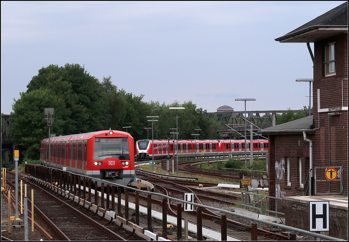 Zweimal S-Bahn -

Ein S-Bahnzug der Baureihe 474 erreicht den Bahnhof Hamburg-Barmbek. Auf dem Abstellgleis ein abgestellter Zug der Baureihe 490.

17.08.2018 (M)
