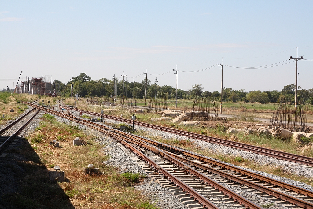 Zwischen der Nong Kuai Station und der Ban Phachi Junction beim Strecken-Km 92 der Northeastern Line zweigt die Güterzugsschleife zur Northen Line ab. - Im Bild vom 04.Dezember 2025 die Weichenverbindung zur Schleife und links im Hintergrund die ersten Pfeiler der Trasse der HSR Northeastern Line.