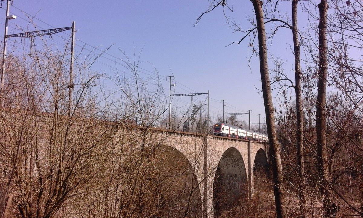 Zwischen Uzwil und Wil SG überspannt die Thurbrücke den gleichnamigen Fluss bei Schwarzenbach. Hier überquert der IR 13, von einem Zürcher KISS geführt, die Brücke auf seinem Weg nach St. Gallen.
Heute hatte ich noch Glück, dieses Bild zu schiessen. Wenn die Blätter dann an den Bäumen hängen, wird ein Bild von diesem Standpunkt aus sehr schwierig umzusetzen.

Schwarzenbach SG, 24.03.2019