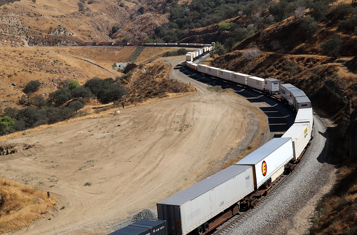 BNSF-Güterzug befährt die fotogene Doppelkurve nach Tunnel 3 bei Bealville. Bealville, CA, 28.9.2022