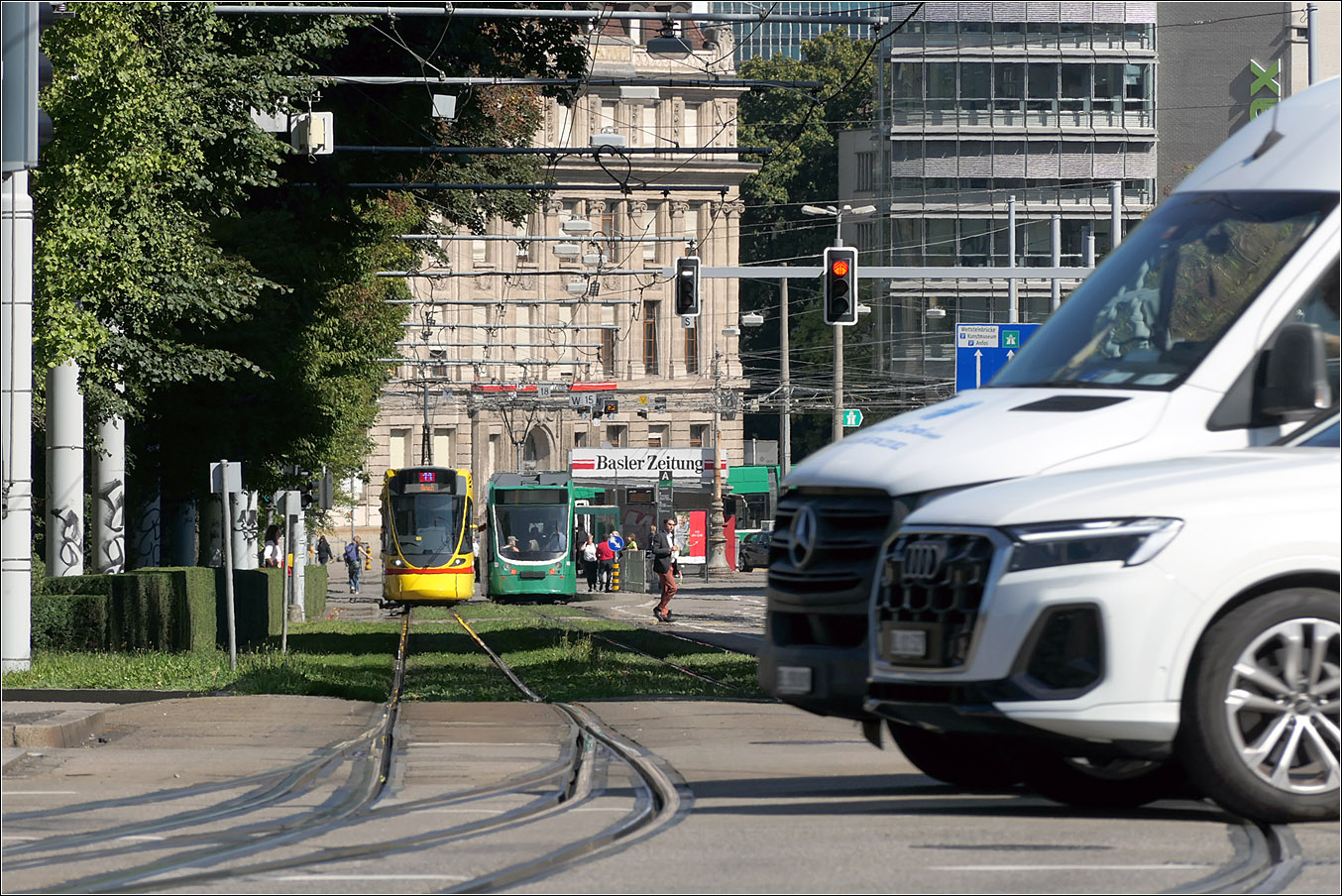 Da sind mir zwei Kraftfahrzeuge ins Bild gerauscht - 

Aber gerade dies macht das Bild interessant. 

Der Blick geht hier von der Haltestelle Bahnhof SBB in den Aeschengraben mit einer Tango-Tram der BLT und einer Combino-Tram der BVB. Das traditionelle Grün der BVB-Trams halte ich für Straßenbahnen eigentlich nicht so ideal, da sie doch etwas im Straßenbild untergehen. Straßenbahnen sollten sehr auffällig sein um auch Unfälle zu vermeiden. 

Spannend auch die Weiche im Vordergrund links mit zweifachem Abzweig.

18.09.2025 (M)

