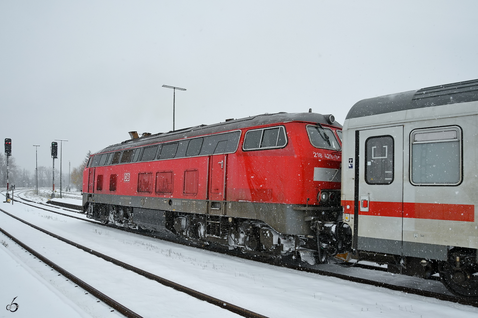 Der von der Diesellokomotive 218 429-9 gezogene IC setzt sich langsam in Bewegung, so gesen Ende November 2023 am Hauptbahnhof Kempten.