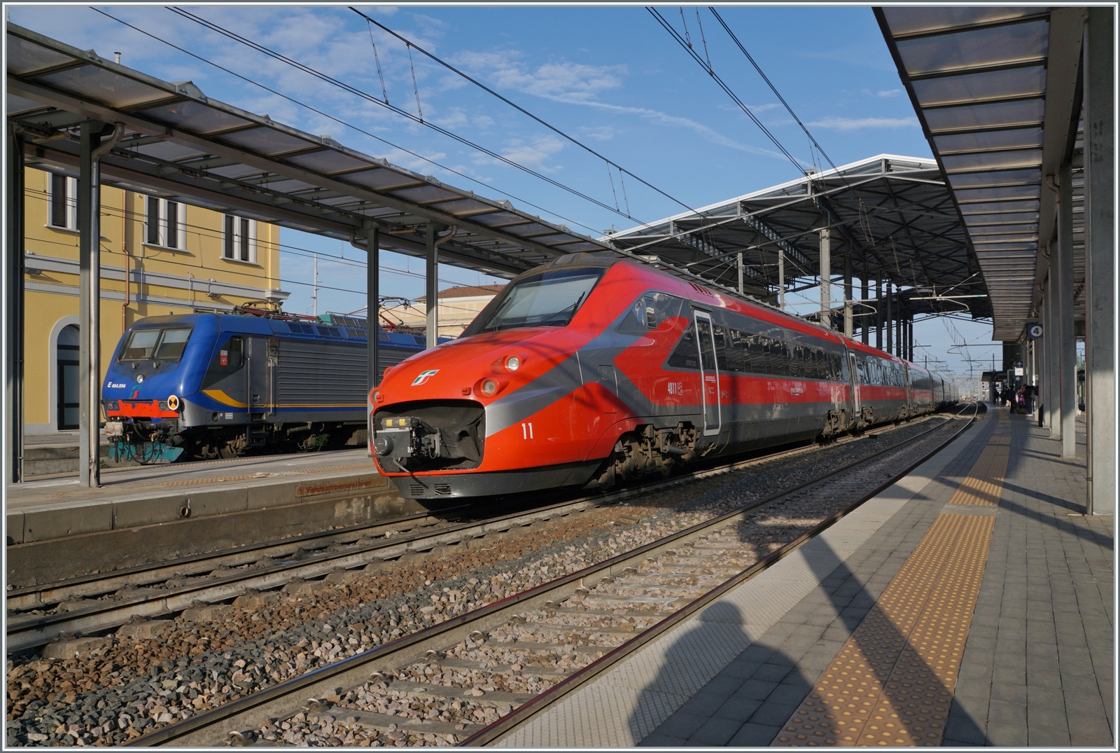 Der FS Trenitalia ETR 700 011 (ex Fyra) ist als Frecciarossa 8802 von Ancona nach Milano unterwegs und hat den Bahnhof von Parma erreicht. Links im Bild ist ein FS Trenitala Regionazug von La Spezia in Parma angekommen. 

18. April 2023
