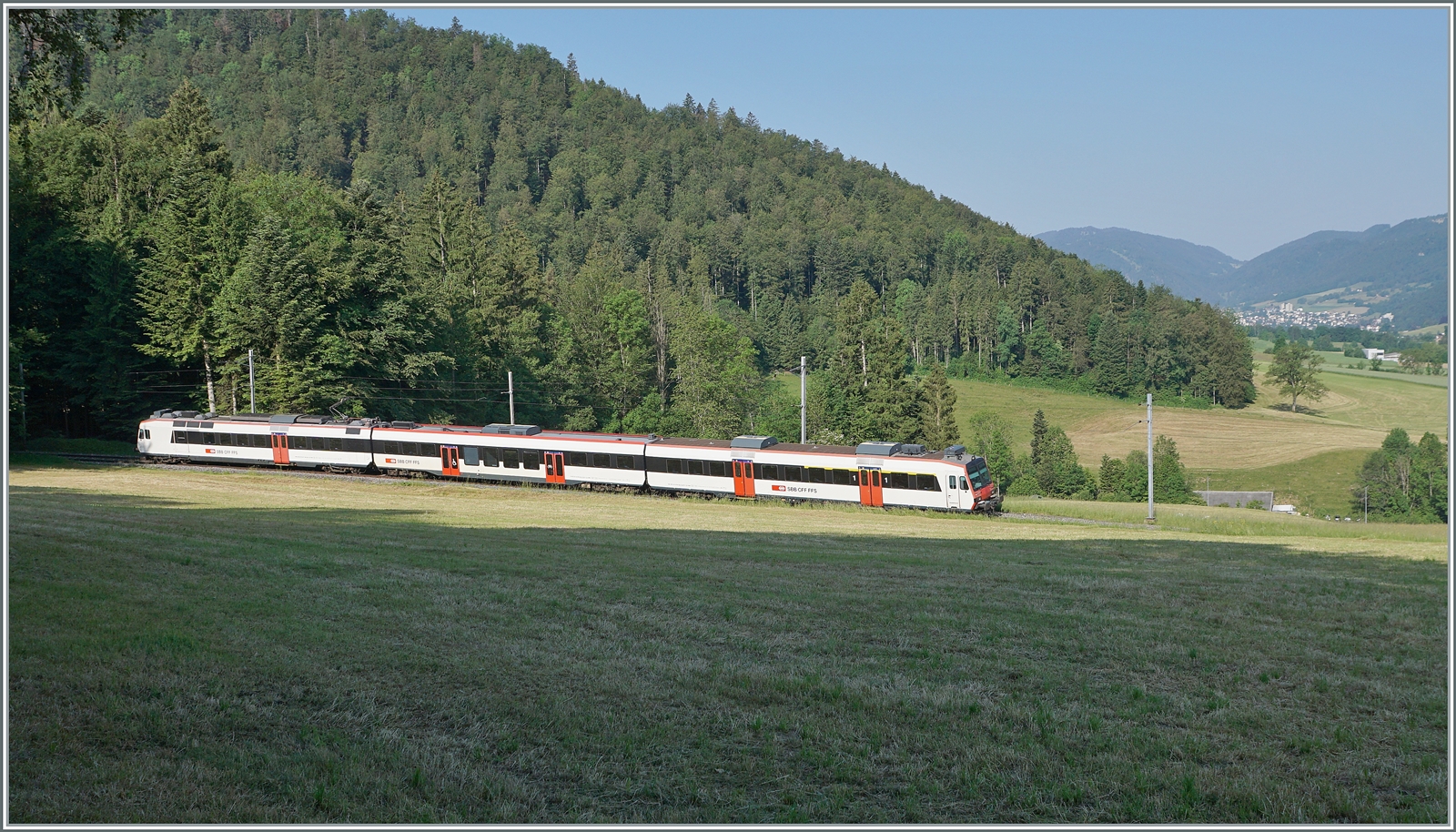 Eine knappe Stunde später oberhalb von Crémines folgt die S21 7831 von Solothurn nach Moutier, ebenfalls in Form eines SBB Domino, welcher auf dem kurzen sonnigen Abschnitt kaum Platz findet. Im rechten Bildteil schweift der Blick bis nach Moutier, das im Hintergrund zu erkennen ist. 

5. Juni 2023