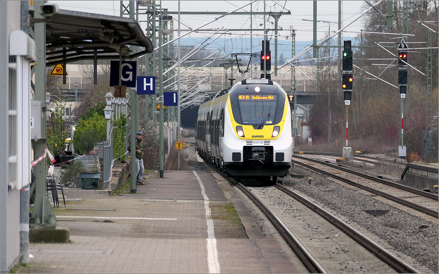 Einfahrt eines Talent II-Triebwagens - 

... 8442 126 als MEX 18 in den Bahnhof Wendlingen. Obwohl der Stuttgarter Hauptbahnhof noch ein Kopfbahnhof ist, wird die Linie nach Heilbronn bzw. Neckarsulm durchgebunden. 

Nach Fertigstellung von Stuttgart 21 wird hier der MEX 13 von Tübingen nach Aalen verkehren, da im neuen Stuttgarter Hauptbahnhof es sinnvoll ist die Strecken die auf den Außengleisen ankommen auf die durchzubinden, die den Bahnhof auch auf den Außengleisen verlassen, das heißt von der Zuführung Untertürkheim zur Zuführung Bad Cannstatt. Das gleiche gilt für die Innengleise vom Fildertunnel nach zur Zuführung Feuerbach. So werden Gleiskreuzungen im Vorfeld des Bahnhofes vermieden. Der Bau der P-Option von der Zuführung Bad Cannstatt nach Feuerbach wird da mehr Flexibilität ermöglichen.

21.02.2024 (M)