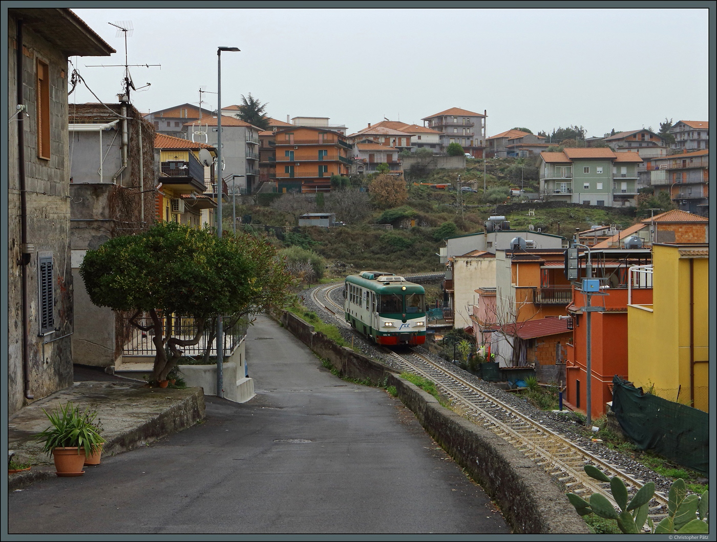 In Bronte schlängelt sich die FCE noch mitten durch den Ort, während sie an anderer Stelle oft in den Untergrund verbannt wurde. ADe 16 passiert am 27.02.2024 das Einfahrsignal des Bahnhofs, der hier am Rande der Altstadt liegt.