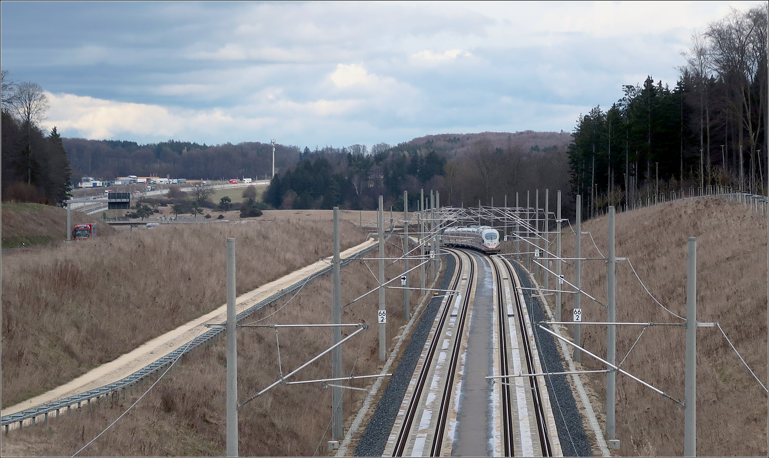 In langgezogenen Bögen über die Alb -

... folgt die Schnellfahrstrecke Wendlingen - Ulm der Autobahntrasse um nicht ein zweites Mal die Landschaft zu durchschneiden. Bündelungstrasse wird dies genannt. 
Hier ein Nachschuss auf einen ICE 3 der Merklingen passiert hat und in wenigen Minuten Ulm erreichen wird. Links im Hintergrund kann anhand der Masten der weitere Verlauf der Strecke neben der Autobahn erahnt werden.

14.03.2023 (M)
