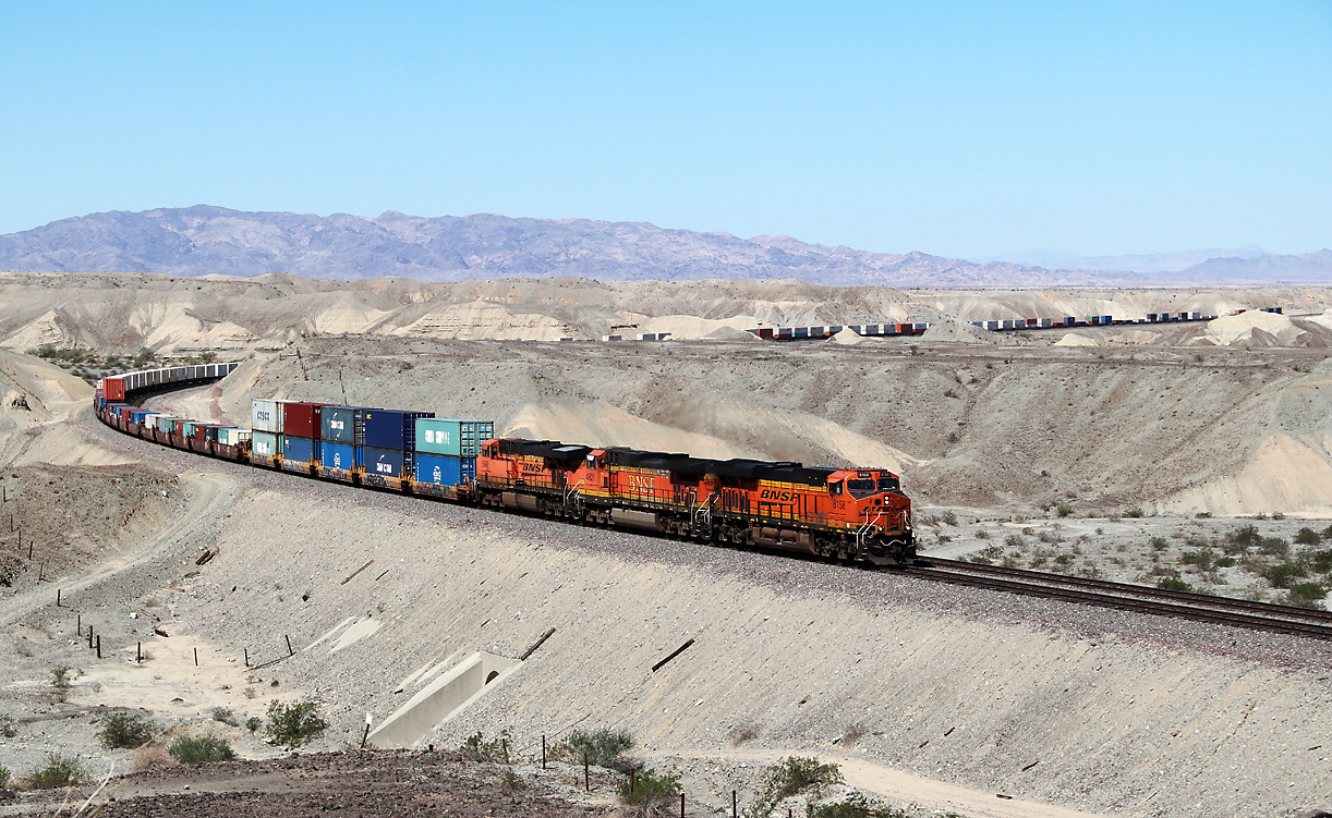 Intermodal Train (Containerzug) ein paar Meilen östlich von Needles, CA. In wenigen Augenblicken überquert dieser Zug die Staatsgrenze Kalifornien/Arizona. Dies ist ein sehr guter und leicht erreichbarer Fotopunkt auf einer Strassenüberführung. Needles, CA, 19.9.2022