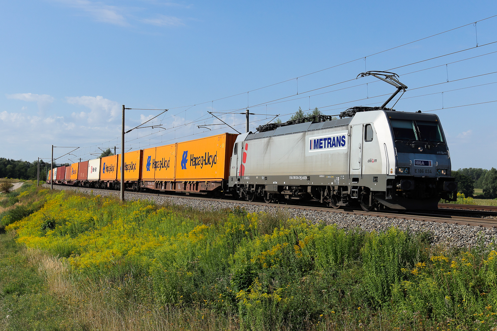 Metrans 186 034 NL mit Containern am Hacken am 11 August 2026 bei Vierkirchen.