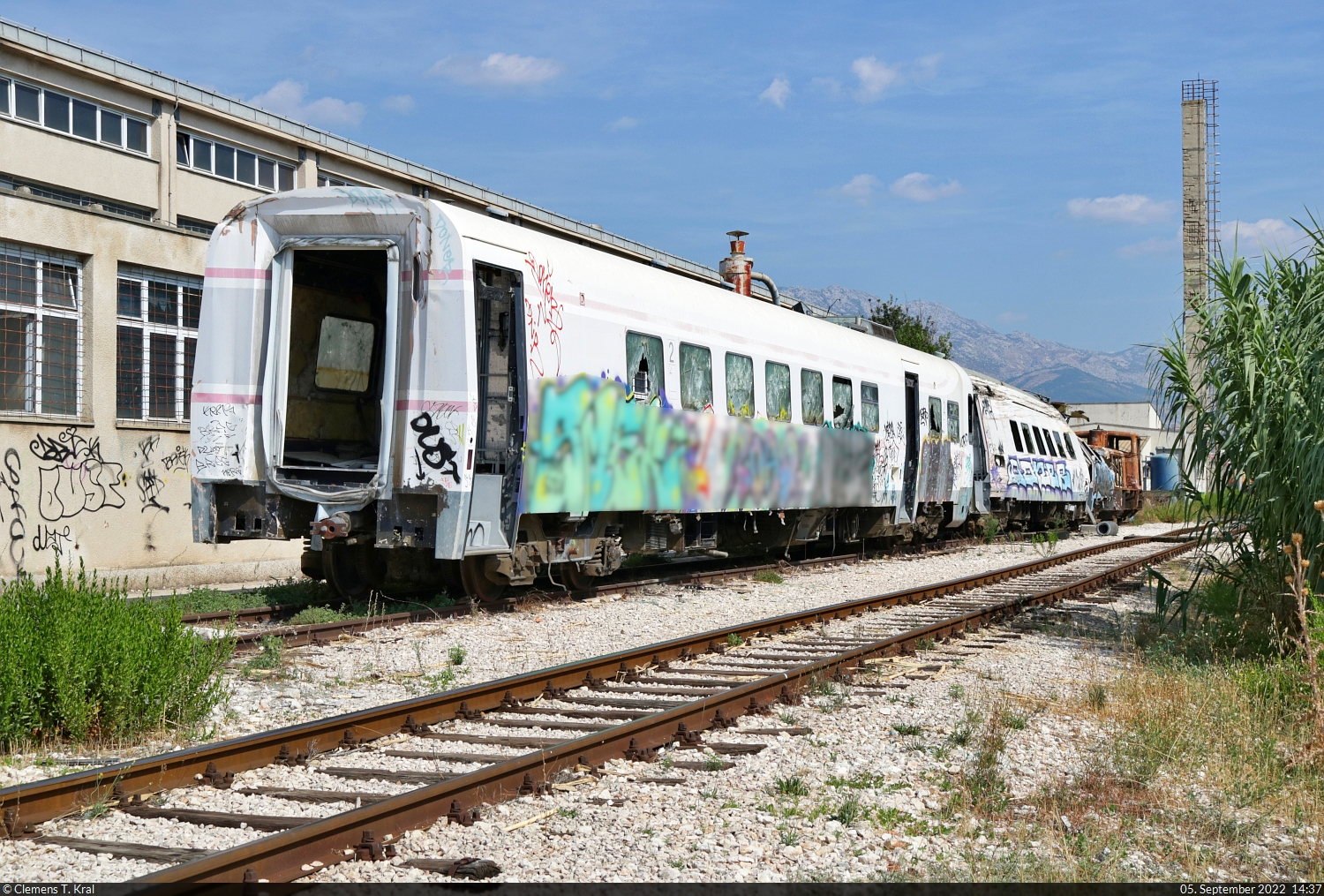 Noch immer fristen die verunglückten Triebzug-Hälften 7123 009 (95 78 7123 009-8 HR-HŽPP) und 7123 010 (95 78 7123 010-6 HR-HŽPP) ihr Dasein auf einem Abstellgleis im Bahnhof Solin (HR).
Der Zug entgleiste 2009 bei Kaštel Stari, weil er zu schnell einen Bogen befuhr. Ursache war ein Brandschutzmittel, das zuvor Bahnmitarbeiter nicht nur auf die Holzschwellen, sondern auch auf die Schienen auftrugen. Der Zug konnte dadurch nicht mehr rechtzeitig bremsen.
Der Zustand der Bombardier RegioSwinger wurde von einem Weg am Boots-Anleger von Solin dokumentiert.

🧰 HŽ Putnički prijevoz (HŽPP)
🕓 5.9.2022 | 14:37 Uhr