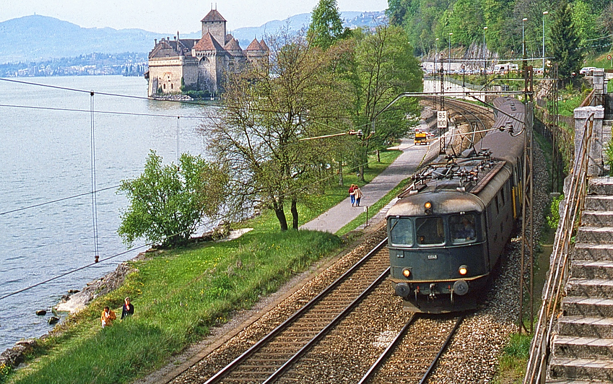 Re 4/4 I 10045 fährt im Mai 1981 vorbei am Schloss Chillon den Genfer See entlang