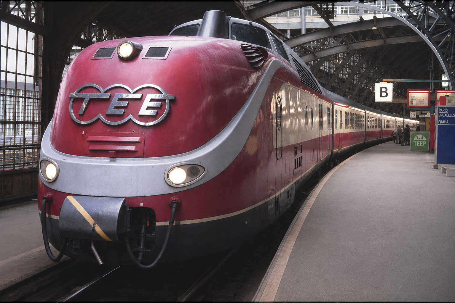 VT11.5 im K�lner Hauptbahnhof. Urspr�nglich eine Dia-Aufnahme aus der Zeit Ende der 80er / Anfang der 90er Jahre. Diese Aufnahme wurde mittels ChatGPT optimiert. So wurden Wasserpf�tzen, die auf dem Bahnsteig das Gesamtbild st�rten, entfernt. Ebenso entfernt wurde der Lokf�hrer, der seitlich aus den F�hrerstand gedankenverloren auf den Boden schaute. Die Schildbefriftungen auf dem Bahnsteig sind Phantasieerzeugnisse, welche auf dem urspr�nglichen Dia nicht eindeutlig lesbar sind, aber erkennbar einen anderen Inhalt haben. Insgesamt wurde das Bild nachgesch�rft. 
