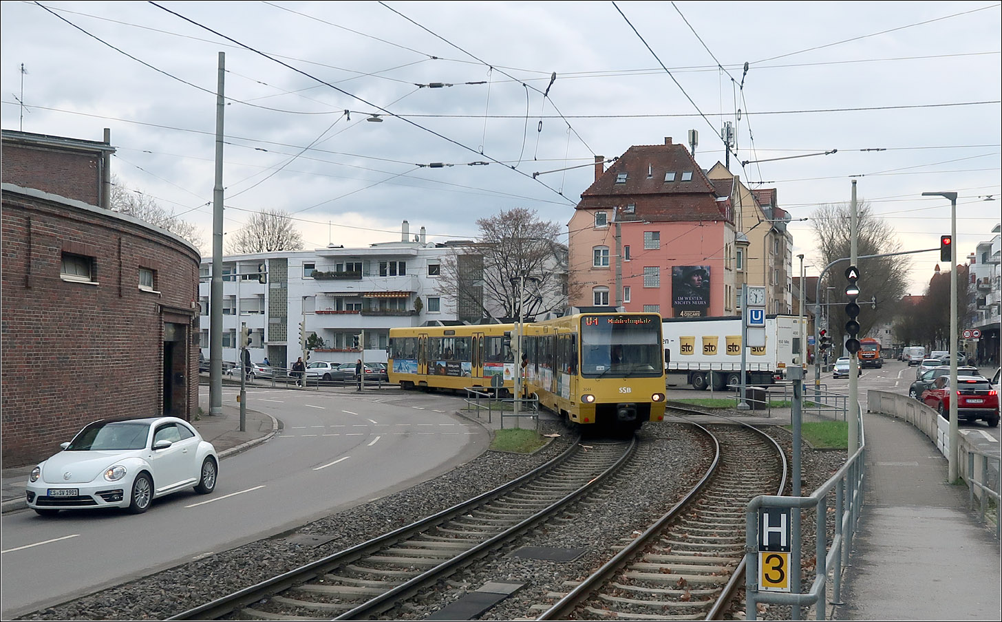 Wenig verändert -

... hat sich seit Aufnahme des Stadtbahnbetriebs auf der Linie 9 im Jahr 1989 die Situation an der Haltestelle Inselstraße. Zuvor fuhr die Straßenbahn rechts in der Ulmer Straße durch den Ortskern von Wangen. Die Stadtbahn wurde auf den vorhandenen Strecken der Linie 4 (Inselstraße) und 13 (Wasenstraße) im Bogen um den Ortkern geführt, da hier eigene Bahnkörper vorhanden waren.
1994 wurde auch die hier verkehrende Linie U4 auf Stadtbahnbetrieb umgestellt und die Haltestelle Inselstraße erhielt Hochbahnsteige. 
Im Bild ein Stadtbahnwagen der ersten Serie (DT-8.4), der nicht umgebaut wurde, passend zur wenig veränderten Situation an dieser Stelle.

13.03.2023 (M)