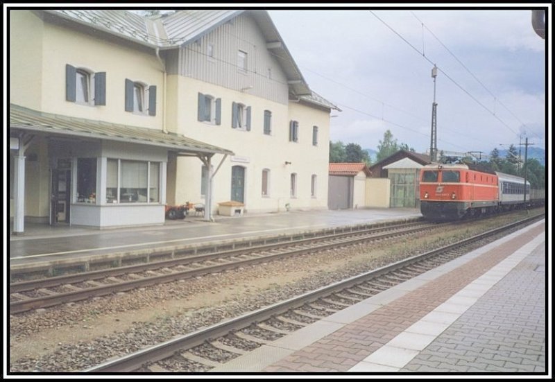 1044 097 rollt im Sommer 2000 mit einer Rollenden Landstrae von Manching zum Brennersee, durch den Bahnhof Kiefersfelden. Anstelle eines Begleitwagens von Kombiverkehr ist ein Wagen der BB eingereiht.