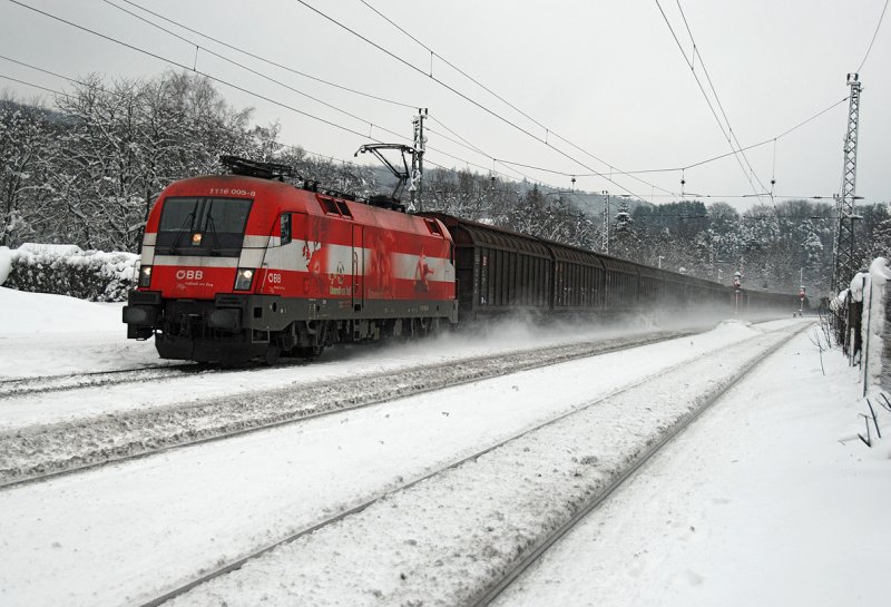 1116 005 vor einem G�terzug Richtung Westen. Winter in Tullnerbach-Pressbaum am 31.01.2009.