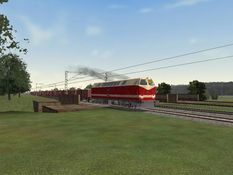 119 074-4 der DR mit Kieszug unterwegs.