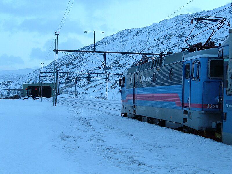 13.01.2006 12:35 Uhr Bjrnfjell: CX Rc 1336 mit Personenzug Narvik - Lulea wartet auf den Gegenzug Stockholm - Narvik. Bjrnfjell ist mit 514 m hchste Station der Erzbahn Lulea - Narvik, Wasserscheide Ostsee - Atlantik und letzter Bahnhof in Norwegen, bis Narvik (Meereshhe) sind es 40 km. Schnee liegt fr diese Jahreszeit wenig, es knnen auch ber 2 Meter sein.