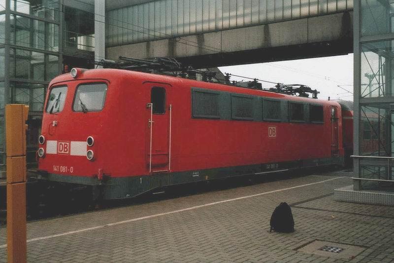 141 081 abgebgelt in Emden.Hinter ihr eine Leergarnitur des Emsland-Express, Oktober 2002.