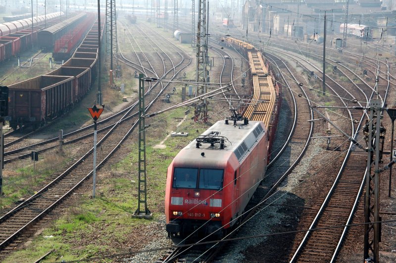 145 012 verlsst am 07.04.09 den Rbf Halle(S) Richtung Berlin/Hannover. Am Haken hatte sie einen Schienentransportzug. Die Langschienen waren ber 4 Rungenwagen geladen.