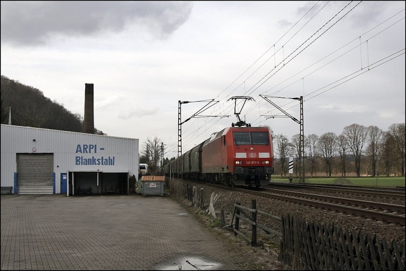 145 072 ist mit einem Coilzug, bestehend aus Waggons der B-CARGO, bei Hohenlimburg in Richtung Siegen unterwegs. (27.03.2009)
