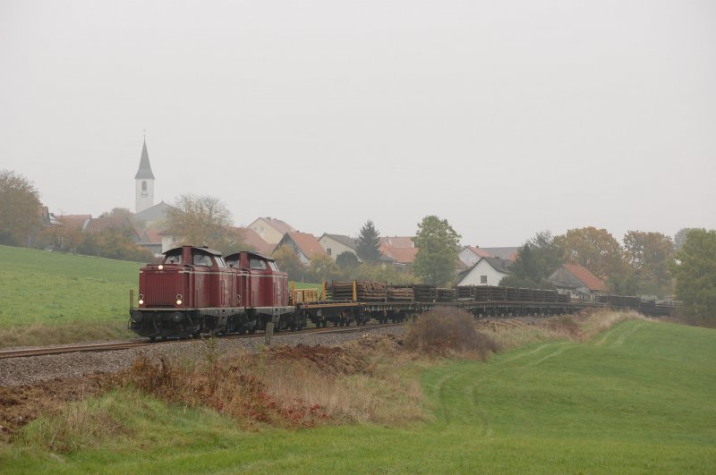 212 370 und 212 047 am 11.10.2008 am Gleisumbauzug vor der Skyline von Gebenbach. (Strecke Amberg-Schnaittenbach)