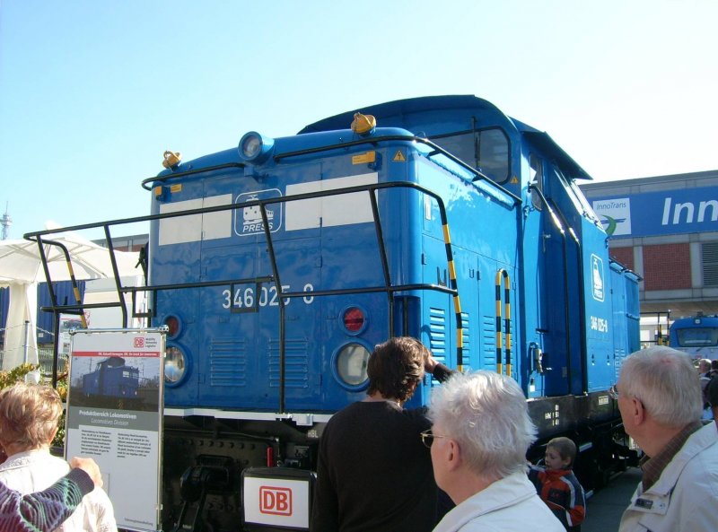 346 025 der PRESS wirbt auf der Innotrans fr den  Pruduktbereich Lokomotiven  der DB. Da stellt sich mir die Frage warum die Bahn nicht eine von ihren Loks ausstellte!