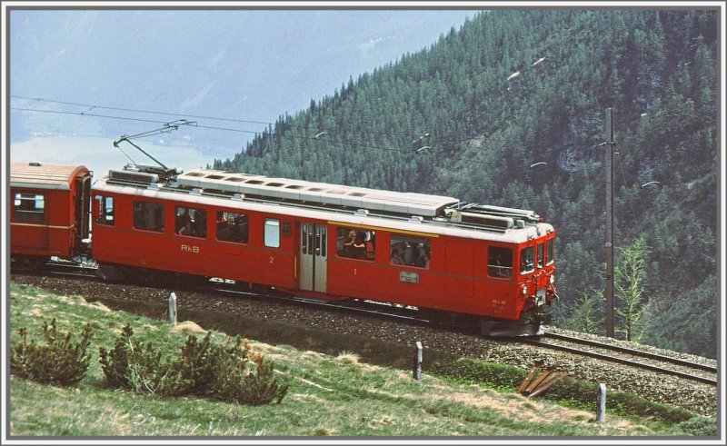 ABe 4/4 48 auf Talfahrt in der Alp Grm Kurve. Im Hintergrund der Puschlaversee. (Archiv 06/83)