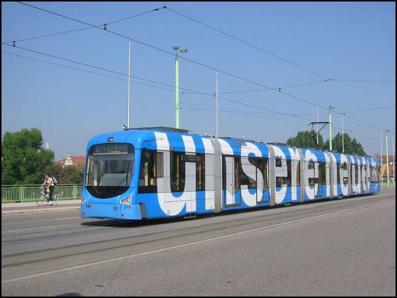 Am 11.05.2006 fhrt diese Straenbahn der Linie 3 ber die Theodor-Heuss-Brcke in Heidelberg. Auffllig ist die Werbung  UNSERE NEUE , was sich eventuell auf diesen Triebwagen 276 bezieht.