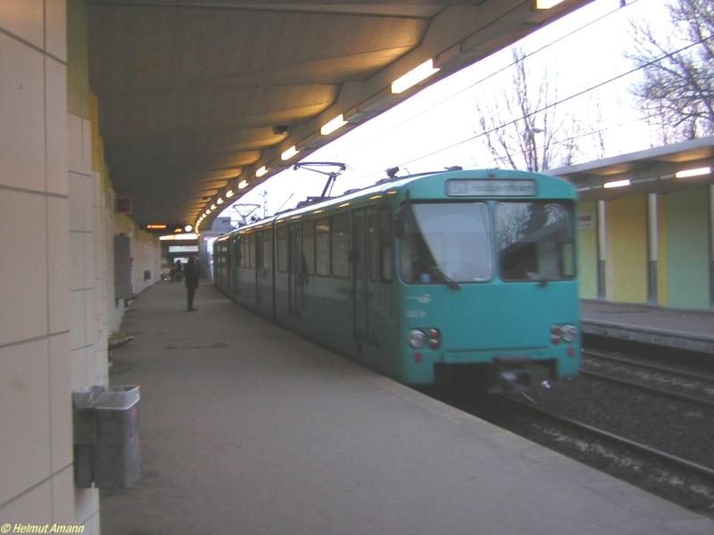 Am Bahnsteig der Station R�merstadt warteten am 25.02.2006 nicht gerade viele Fahrg�ste, als der 7. Zug der Linie U1 nach Heddernheim um 17.50 Uhr mit den Triebwagen 405, 406 und 402 einfuhr. Bei diesen Triebwagen handelt es sich um nachbestellte Triebwagen der Bauart U2, deren Bauserie eigentlich bei der Betriebsnummer 399 endete. Bei einem Gro�brand im U-Bahn-Depot Heddernheim anno 1980 wurden f�nf Fahrzeuge zerst�rt, so da� bei dem Hersteller neue Fahrzeuge als Ersatz daf�r bestellt wurden. Dadurch wurde die Fahrzeugnummer 400 �berschritten.   