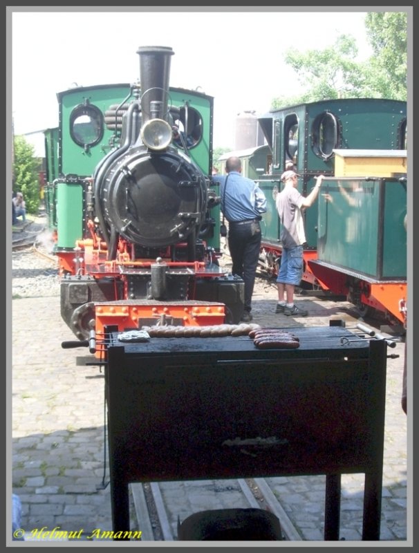 Atmosph�re beim Feldbahnfest am 31.05.2008 im Frankfurter Feldbahnmuseum: Glut unter den Bratw�rstchen auf dem Holzkohlengrill und Glut in der Feuerb�chse der davor stehenden im Jahre 1939 bei Henschel & Sohn gebauten Lok Nummer 6 vom Typ Fabia.