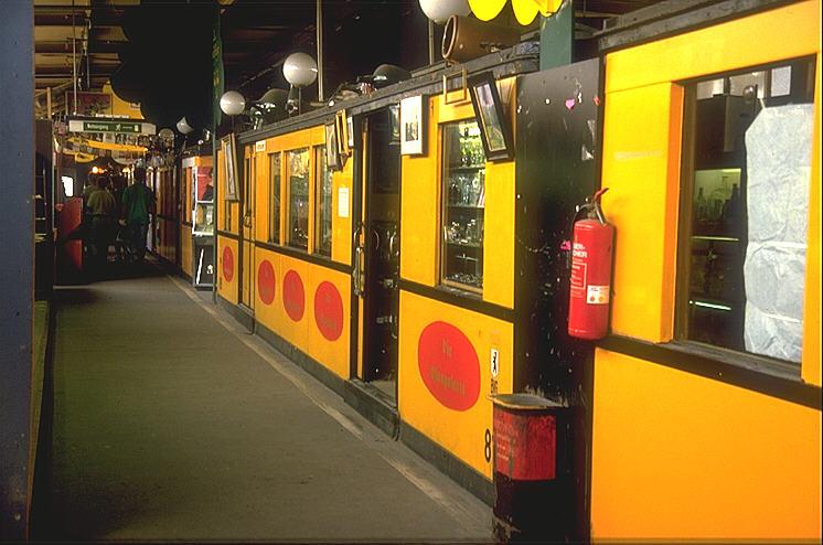 Auf der 1972 stillgelegten Hochbahnstrecke(Kleinprofil)zwischen Wittenbergplatz und Gleisdreieck,befand sich von 1973-1991
im Hochbahnhof Nollendorfplatz ein Flohmarkt.In 16 ausgedienten A2 Wagen wurde jeglicher  Tr�del  angeboten.Heute fahren hier wieder die Z�ge der Linie U2(Archiv P.Walter)