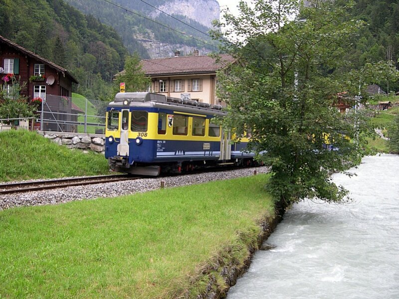 Berner Oberland 2007 - Am Bahnbergang Lochbrcke begegnet uns am 29.07.2007 der ABeh 4/4 308 der Berner Oberland-Bahn, welcher als Regionalzug nach Lauterbrunnen unterwegs ist. Im Vordergrund die Weie Ltschine.